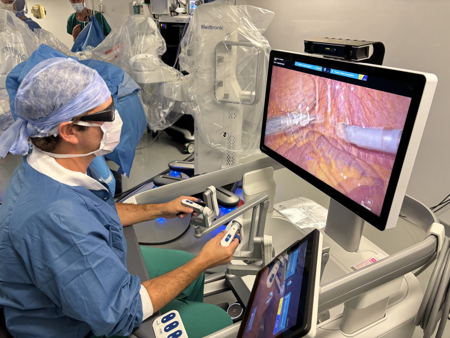 Dr Pierre Fournier at the robot-assisted surgery console, in the operating theatre at Hôpital de Nyon
